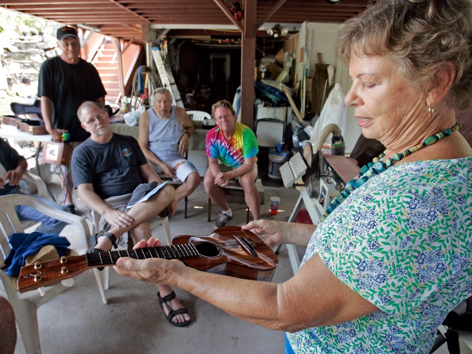 Sonia Edmunds, wife Basil Edmunds, shows off an ukulele begun by Basil and recently finished for her by Bob Gleason