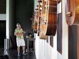 Mike Perdue tries out an ukulele during the exhibit installation