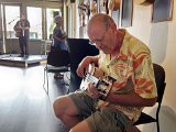 Bass player Lloyd Larsen of Canada tries out a ukulele bass at the exhibit - with permission of course.jpg