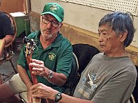 10 - Roger Johnson and Ernesto Bonilla have a look at Doug Powdrell's ukulele