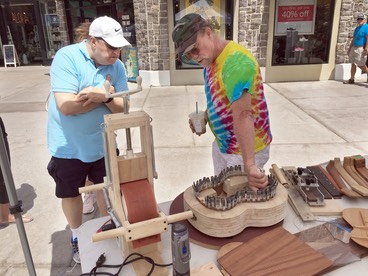 Dave Stokes educates a visito about uke building